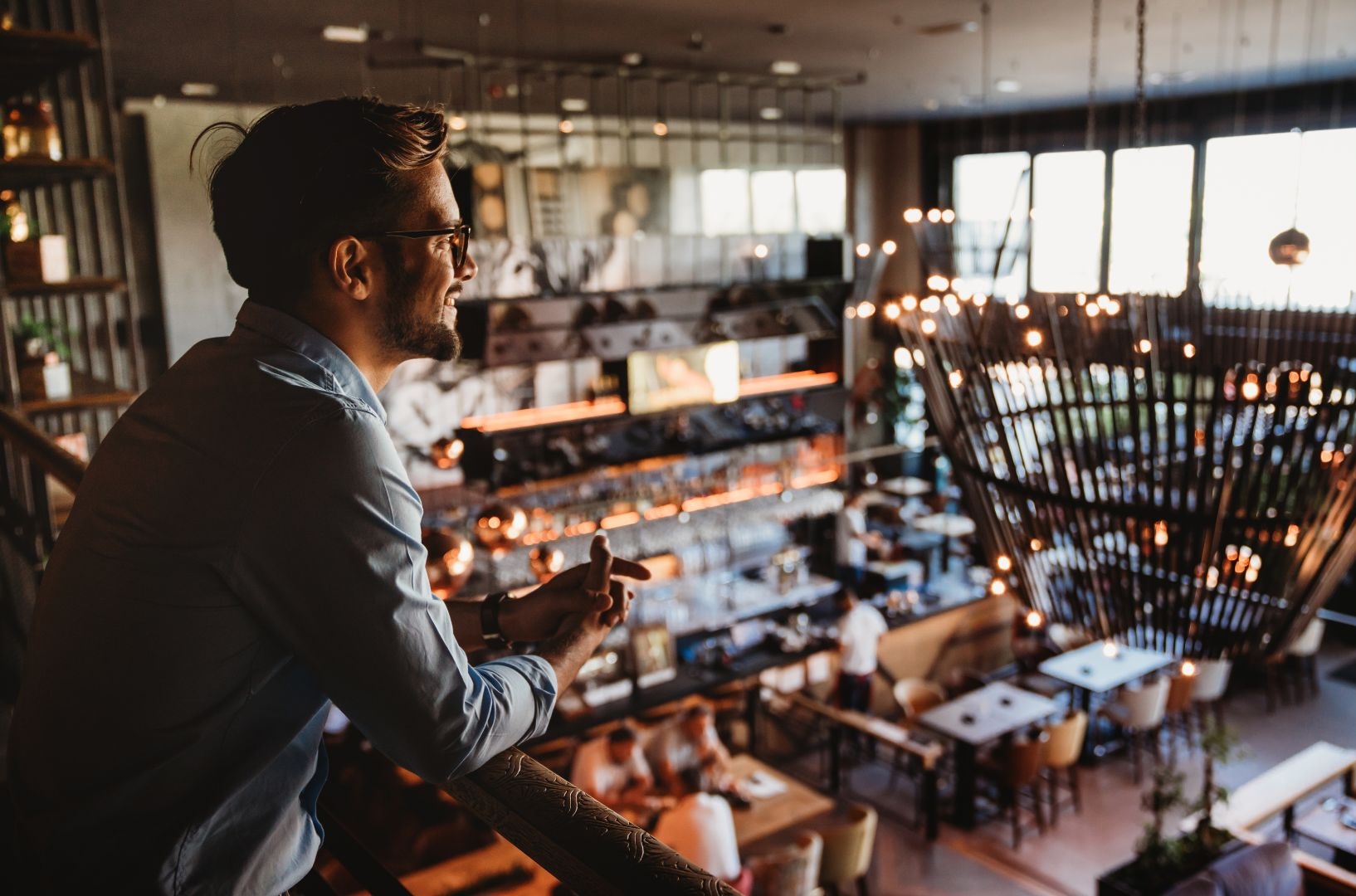 Operator overlooking a busy bar and restaurant venue