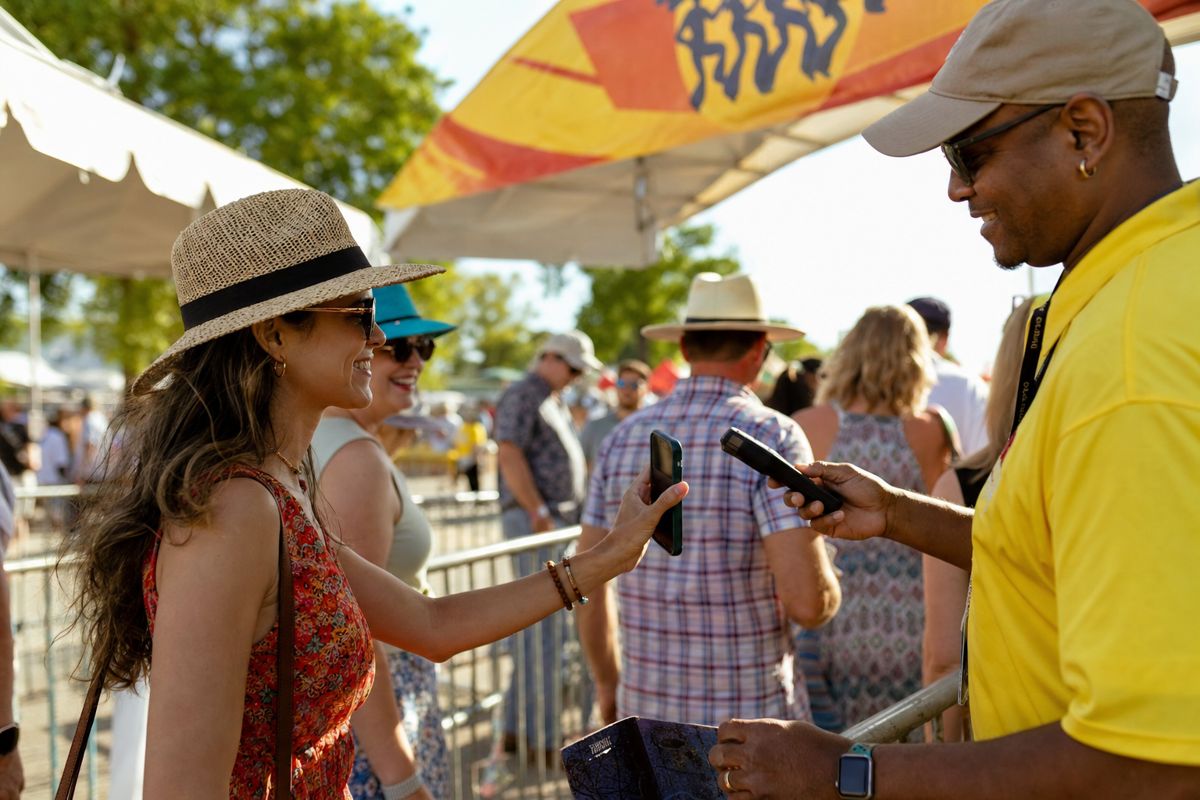 A festival-goer scanning a mobile ticket at the gate